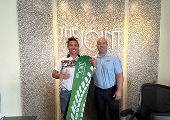 The Joint Chiropractic Ventura Village Staff and Patient