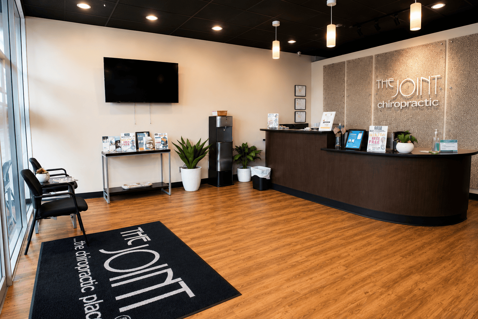 The Joint Chiropractic chiropractor office lobby and front desk in Ocala, Florida.