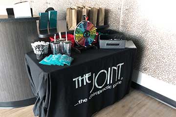 The Joint Chiropractic Garden City Giveaway Table