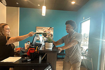 The Joint Chiropractic San Marcos Staff and Patient