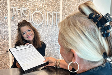The Joint Chiropractic Monroe Staff and Patient 