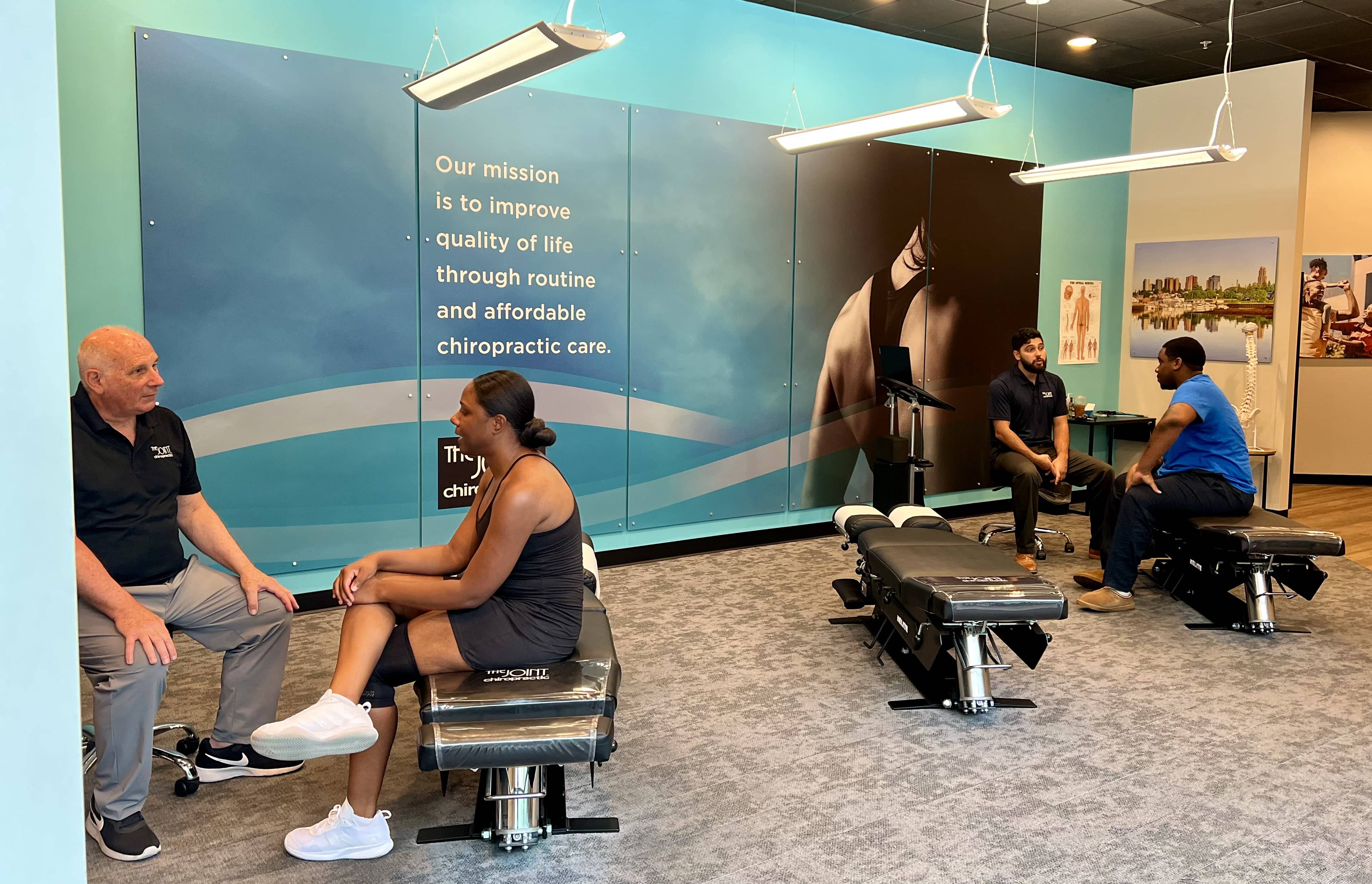New Rochelle chiropractors speak with patients about treatment.