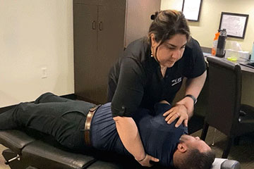 Chiropractor giving patient adjustment at The Joint Chiropractic Northwoods