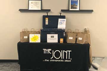 The Joint Chiropractic Garden City Giveaway Table