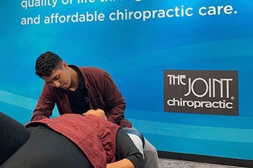 Chiropractor giving patient adjustment at The Joint Chiropractic Thousand Oaks