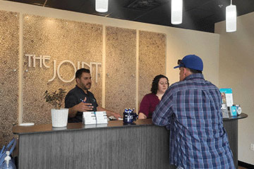 The Joint Chiropractic Round Rock  Staff and Patient